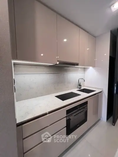 Modern kitchen with sleek cabinetry and built-in appliances, featuring a minimalist design and elegant finishes.