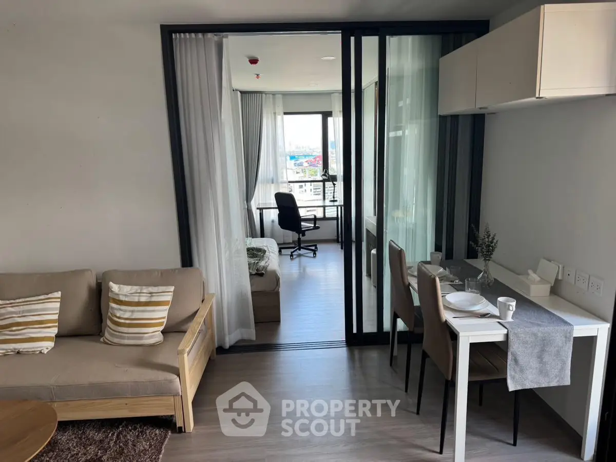 Modern open-plan living room with dining area and city view, perfect for urban living.