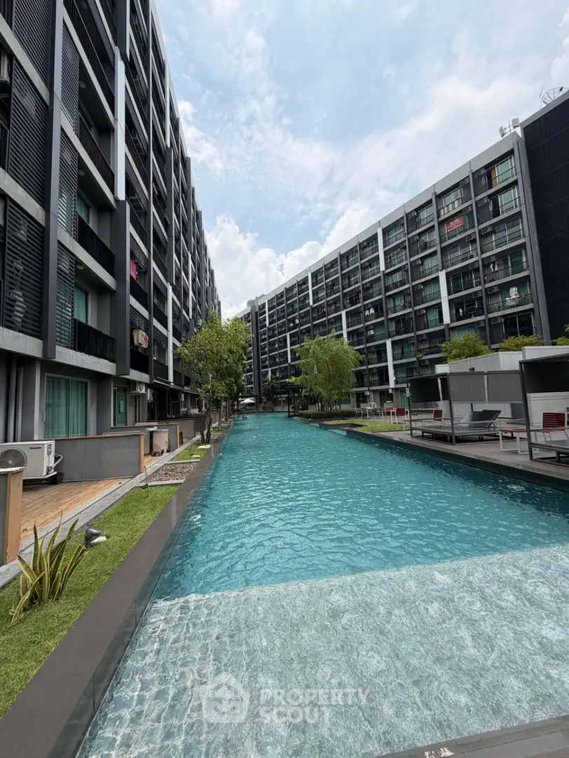 Luxurious modern apartment complex with stunning pool and contemporary architecture.