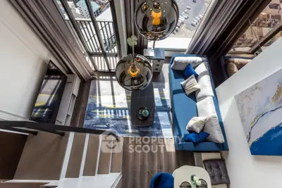 Stunning modern living room with mezzanine and city view, featuring elegant decor and spacious layout.