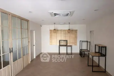 Spacious minimalist living room with wooden flooring and modern decor