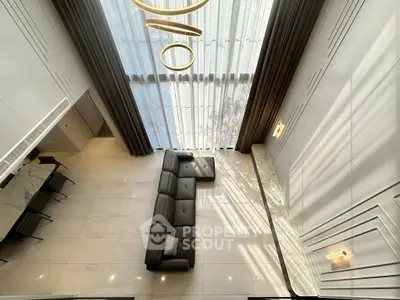 Luxurious modern living room with high ceiling and elegant decor