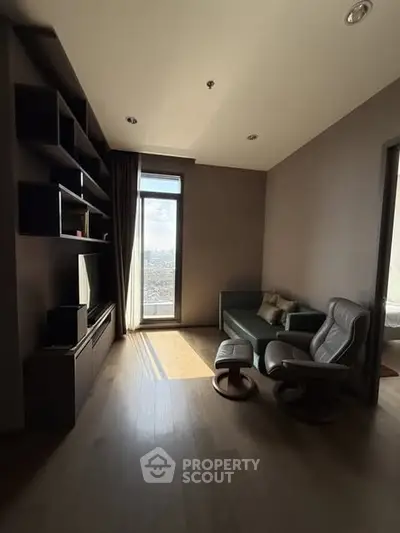 Cozy living room with modern furniture and large window offering city view