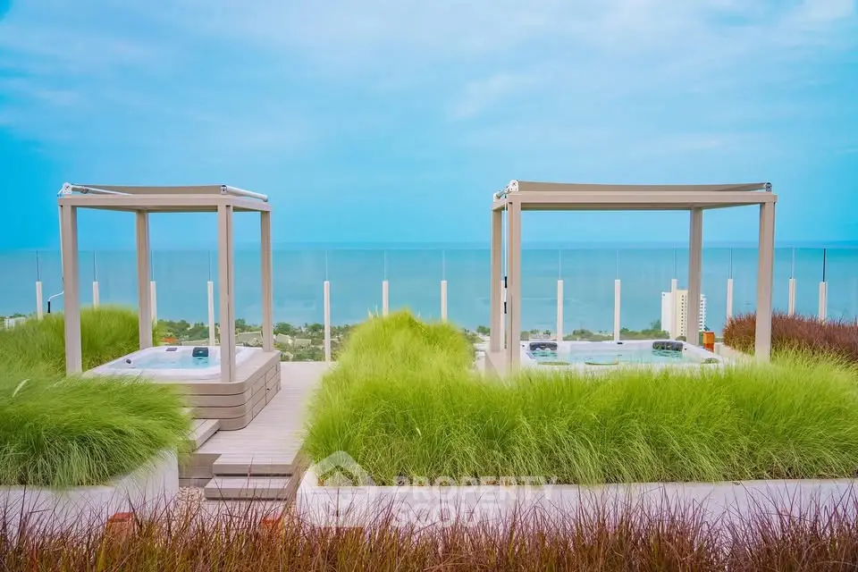 Luxurious rooftop with stunning ocean view and modern cabanas, perfect for relaxation and entertainment.
