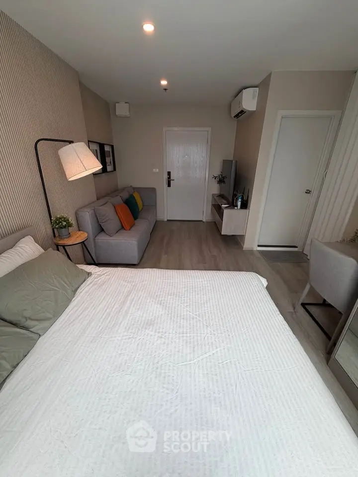 Modern studio apartment with cozy living area and stylish decor
