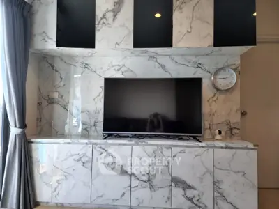 Luxurious living room with marble TV wall and modern decor