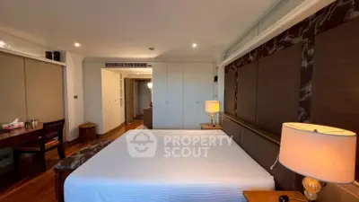 Spacious bedroom with elegant decor and ample natural light