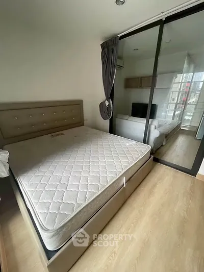 Modern bedroom with large bed and mirrored closet in a stylish apartment