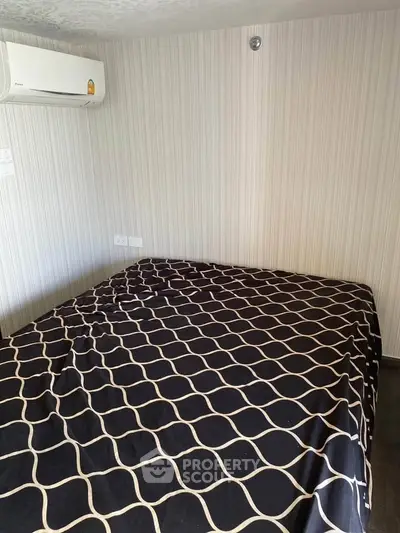 Cozy bedroom with air conditioning and stylish patterned bedding in modern apartment.