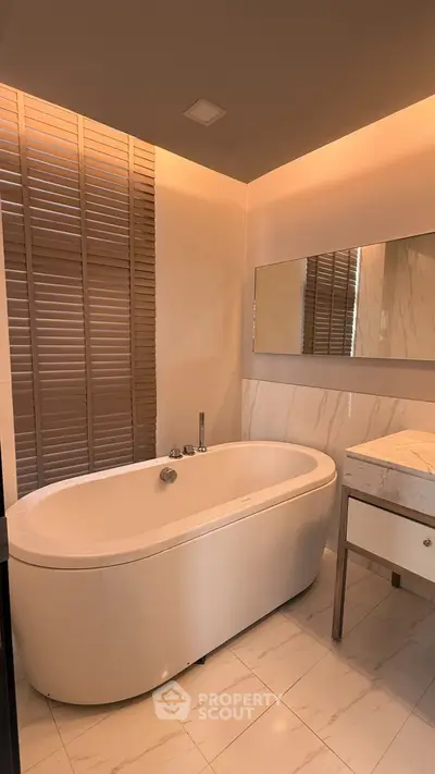 Luxurious bathroom with elegant freestanding bathtub and modern marble vanity.