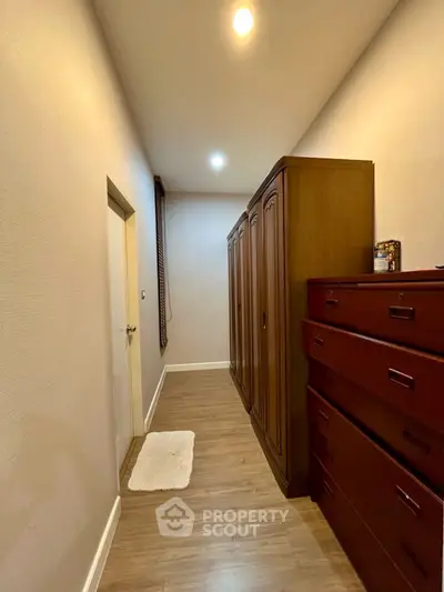 Spacious storage room with elegant wooden cabinets and warm lighting
