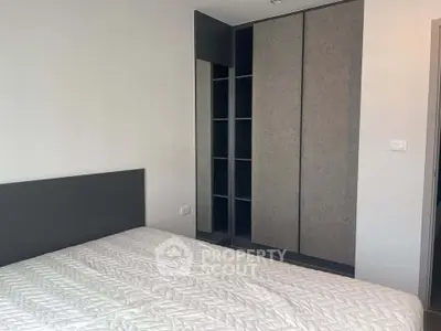 Modern bedroom with sleek built-in wardrobe and comfortable bed