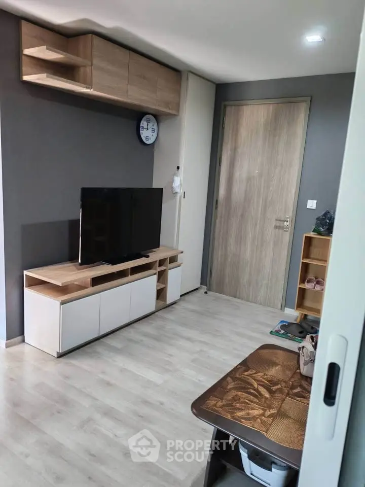 Modern living room with sleek TV stand and wooden flooring