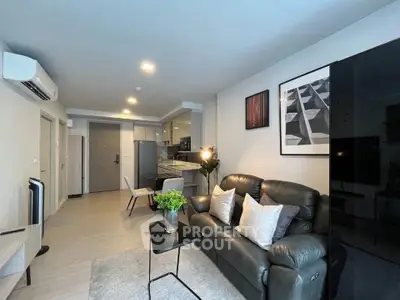 Modern living room with stylish decor and open kitchen layout in a contemporary apartment.