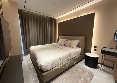 Luxurious modern bedroom with elegant decor and ambient lighting, featuring a plush bed and stylish furnishings.