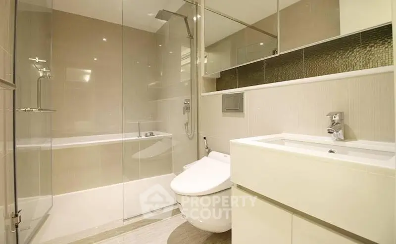 Luxurious modern bathroom with sleek fixtures and glass shower enclosure.