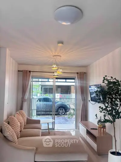 Charming living room with cozy seating and natural light, perfect for relaxation and entertainment.