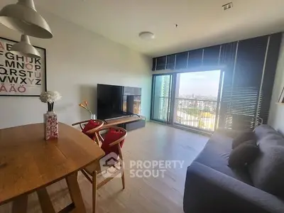 Modern living room with city view, stylish furniture, and large windows for natural light.
