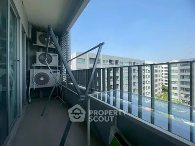 Spacious balcony with city view in modern apartment complex