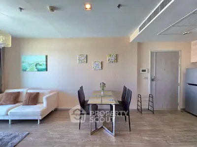Modern living room with elegant dining area and stylish decor in a contemporary apartment.