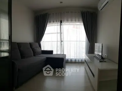 Cozy living room with modern sofa and large window offering city view