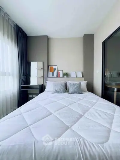 Modern bedroom with stylish decor and large window for natural light
