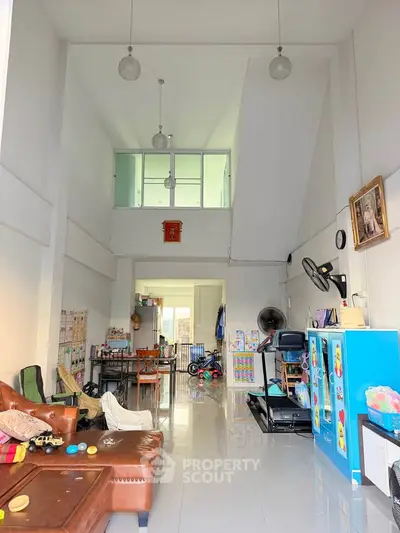 Spacious living room with high ceilings and modern decor, perfect for family gatherings.