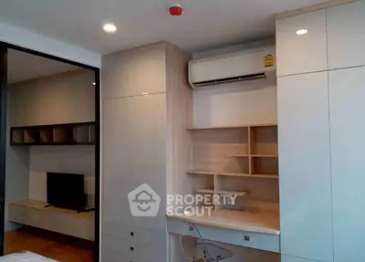 Modern study area with built-in desk and air conditioning in a sleek apartment interior.