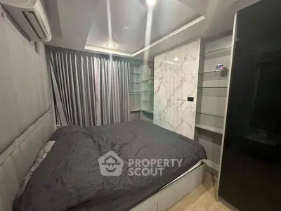 Modern bedroom with stylish marble accent wall and cozy bedding