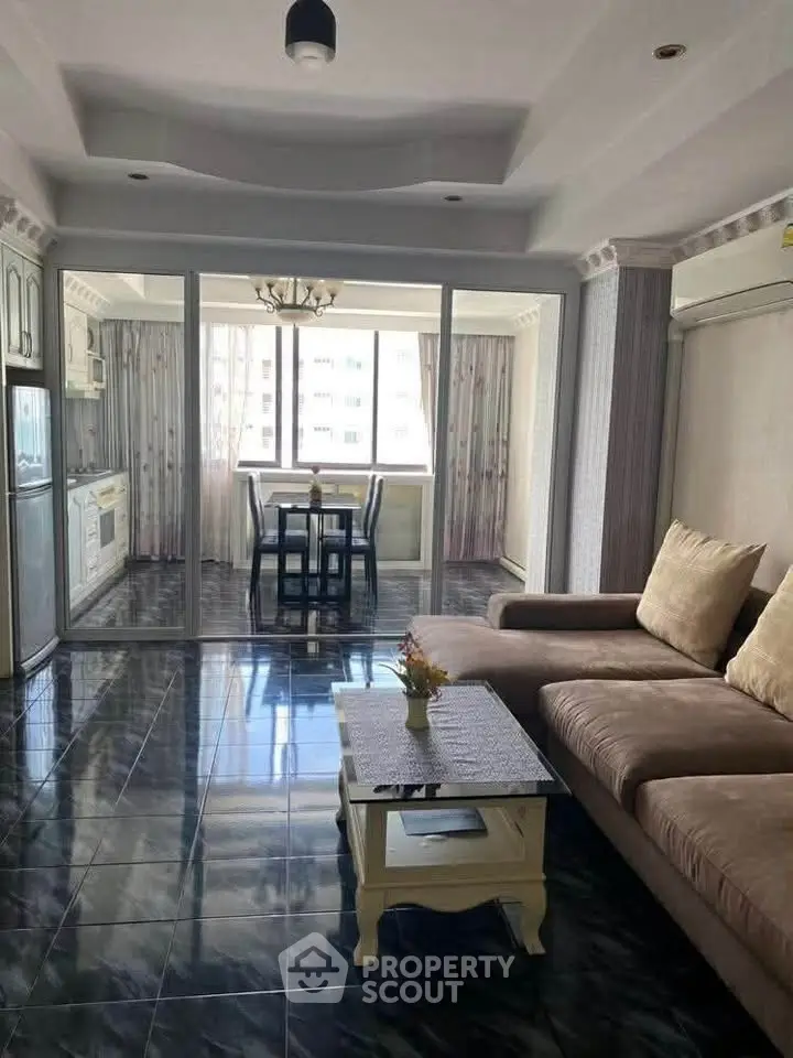 Spacious living room with modern decor and large windows for natural light.