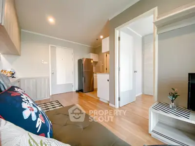 Modern living room with open kitchen and stylish decor in a cozy apartment.