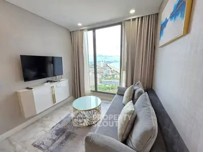 Luxurious living room with stunning city view, modern decor, and elegant furnishings.