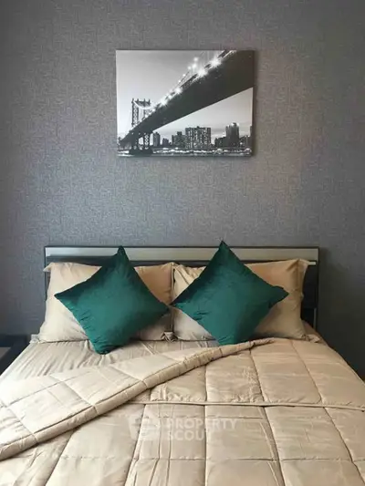 Stylish bedroom with modern decor and elegant bedding, featuring a striking cityscape artwork above the bed.
