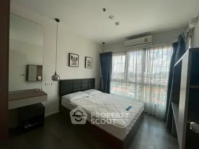 Modern bedroom with large window and city view, featuring minimalist decor and ample natural light.