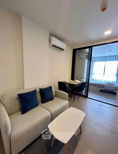 Modern living room with cozy sofa and dining area in stylish apartment