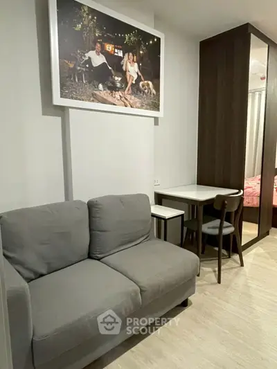Modern living room with cozy gray sofa and stylish dining area