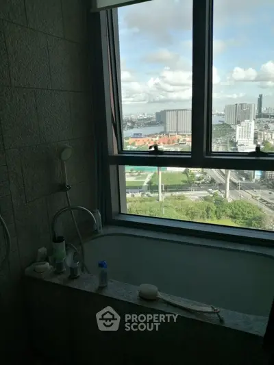 Bathroom with large window offering stunning city view