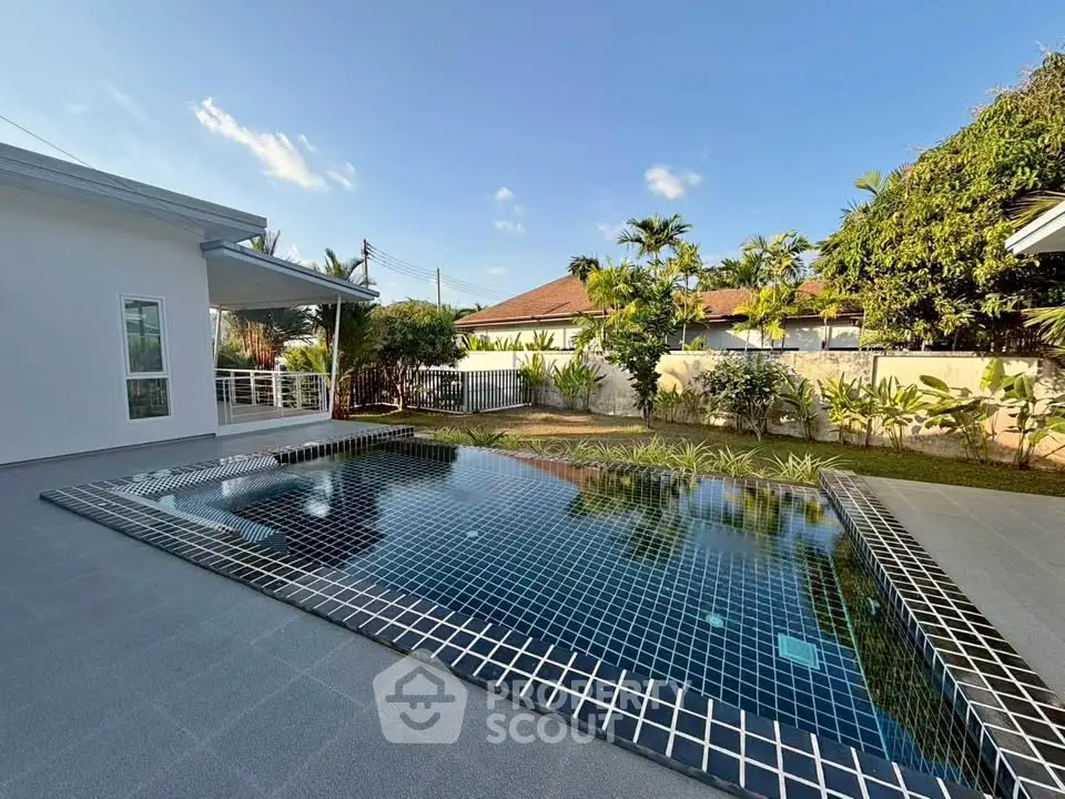 Luxurious private pool in a serene backyard setting with modern design.