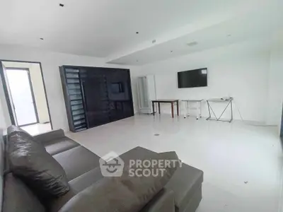 Spacious modern living room with sleek black accents and minimalist design, perfect for contemporary living.