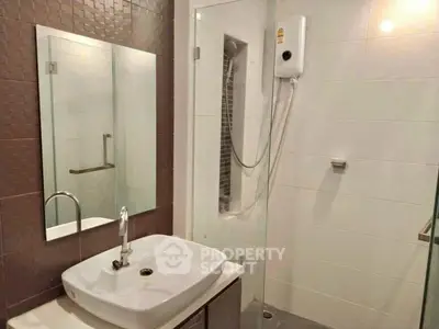 Modern bathroom with sleek sink and shower area