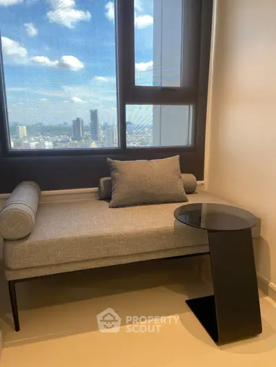 Modern interior with stylish seating and city view from large window.