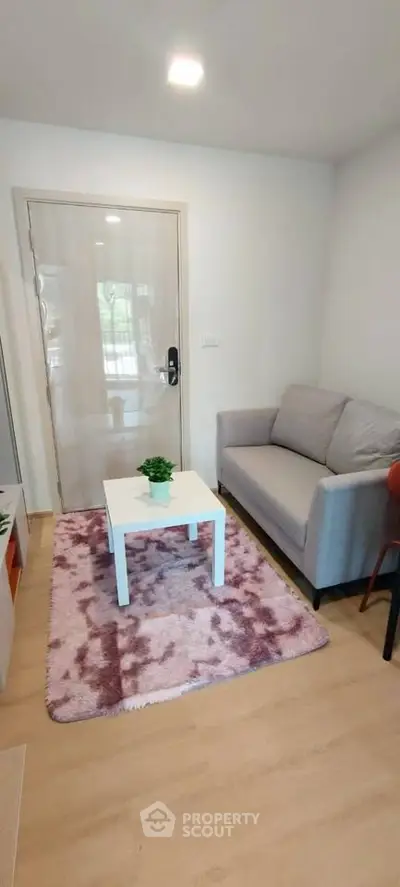 Cozy living room with modern sofa and stylish decor, perfect for relaxation and entertaining guests.