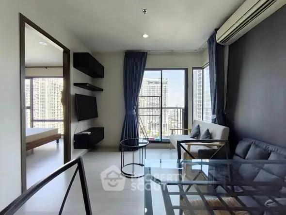Modern living room with city view, featuring sleek furniture and large windows for natural light.