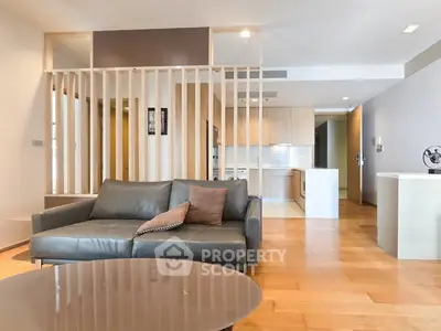 Modern living room with open layout and stylish wooden partition in a contemporary apartment.