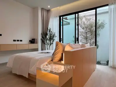 Modern bedroom with large windows and minimalist design, featuring a cozy bed and natural light.