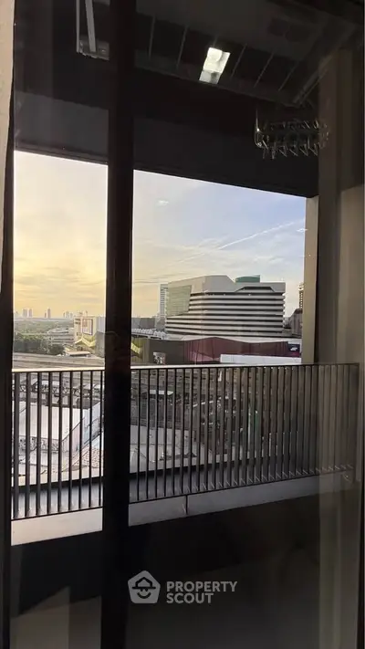 Stunning cityscape view from a modern balcony at sunset, perfect for urban living.