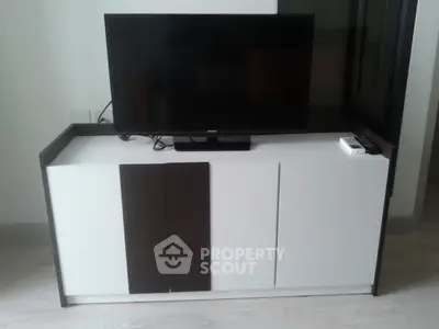 Modern living room with sleek TV stand and flat-screen television, perfect for contemporary home entertainment.