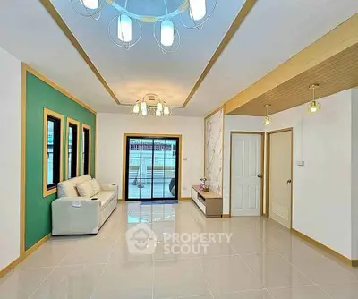 Spacious modern living room with elegant lighting and large windows.