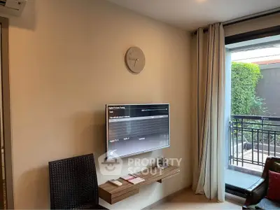 Modern living room with wall-mounted TV and balcony view