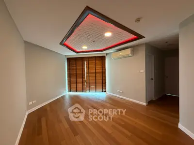 Spacious living room with wooden flooring and modern ceiling design